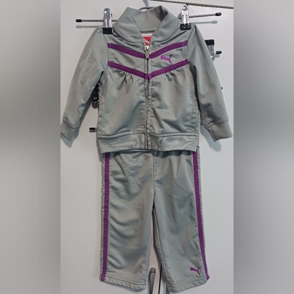 Puma toddler girl's tracksuit, includes a zip-up jacket and matching pants.
